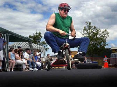 
Marty Phanco struggles with his racing trike while the rest of the crowd watches the front runners in Saturday's Skytona 500. The Big Sky Tavern held its 3rd annual trike races to raise money for the American Cancer Society.
 (Christopher Anderson/ / The Spokesman-Review)