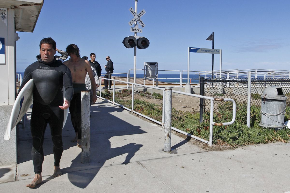 Surfers who were surfing with the 38-year-old victim of a fatal shark attack exit Surf Beach in Lompoc, Calif.  Tuesday, Oct. 23, 2012. The attack was reported by another surfer about 11 a.m. off the coast of Surf Beach, the Santa Barbara County Sheriff