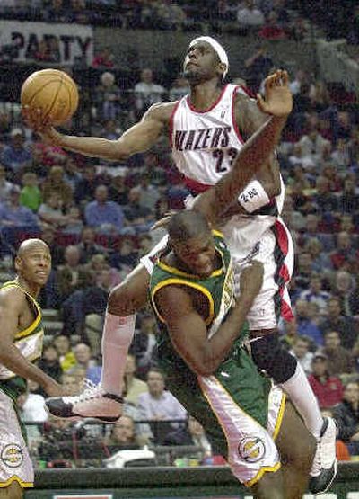 
Portland's Darius Miles charges into Seattle center Jerome James, picking up a first-half offensive foul.
 (Associated Press / The Spokesman-Review)