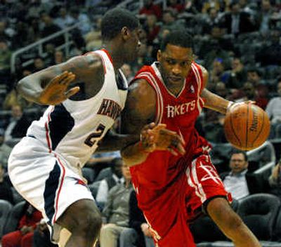 
Houston's Tracy McGrady drives against Atlanta's Marvin Williams during his 28-point effort on Wednesday.Associated Press
 (Associated Press / The Spokesman-Review)
