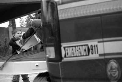 
Students from Post Falls schools, like Ponderosa Elementary first-grader Devin Kelly, participated in the recent community food drive. 
 (Kathy Plonka / The Spokesman-Review)