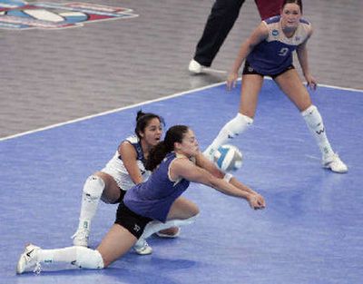 
Washington's Janine Sandell digs the ball next to Tamari Miyashiro, left, and Christal Morrison. 
 (Associated Press / The Spokesman-Review)