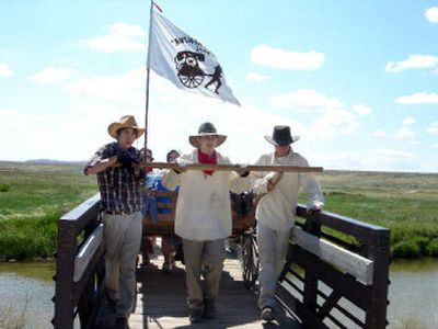 
A group of Mormon youths pull their handcart across a river in Wyoming while on a trip to re-enact a historic trek across Wyoming. 
 (Rhonda Paulson / The Spokesman-Review)