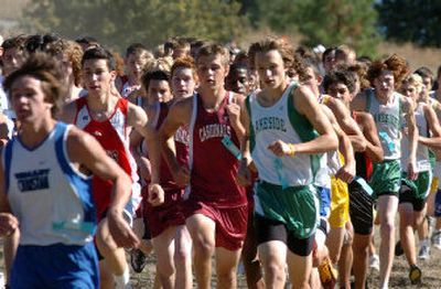 
The pack of boys in the B division leaves the starting area of the Farragut cross country course Saturday at the Farragut Invitational. 
 (Jesse Tinsley / The Spokesman-Review)