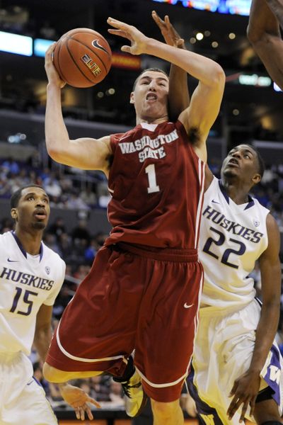 Washington State's Klay Thompson, center, puts up a shot between Washington's Scott Suggs, left, and Justin Holiday during the first half of Thursday night's Pacific-10 tournament game, Thursday, March 10, 2011, in Los Angeles. (Chris Pizzello / Associated Press)