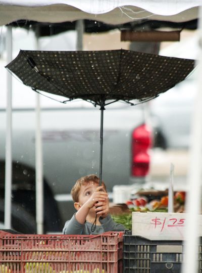 Jacob Melville, 4, catches rain while shopping with his mother, Brandie, in Laguna Hills, Calif., on Friday. (Associated Press)
