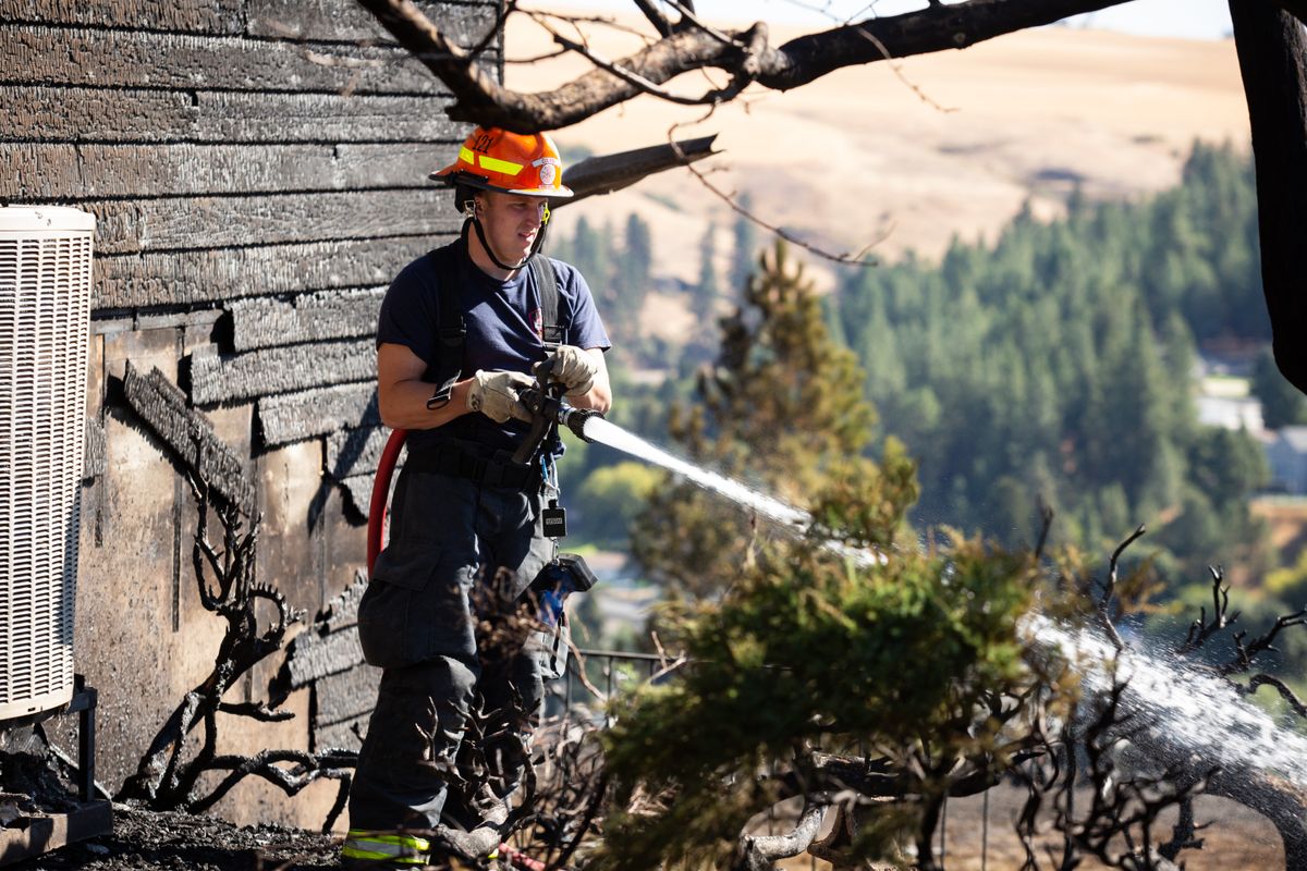 People clean up in Colfax after the fire Sept. 8, 2020 The