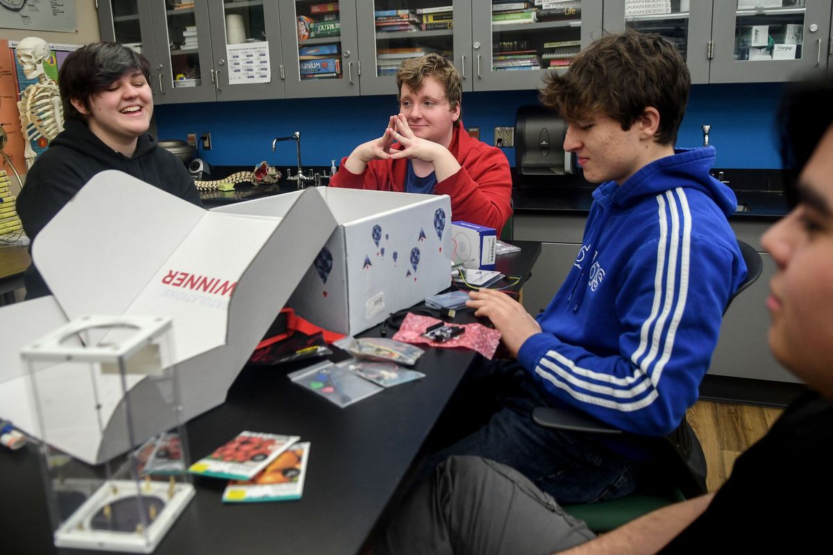 Spokane Valley Tech students, from left, Tobi Townley, Christian Smilden, Paul Kamarov and Nicholas Espana look through a box of supplies from NASA at the school on Feb. 6. The group won the NASA TechRise Student Challenge.  (Kathy Plonka/The Spokesman-Review)