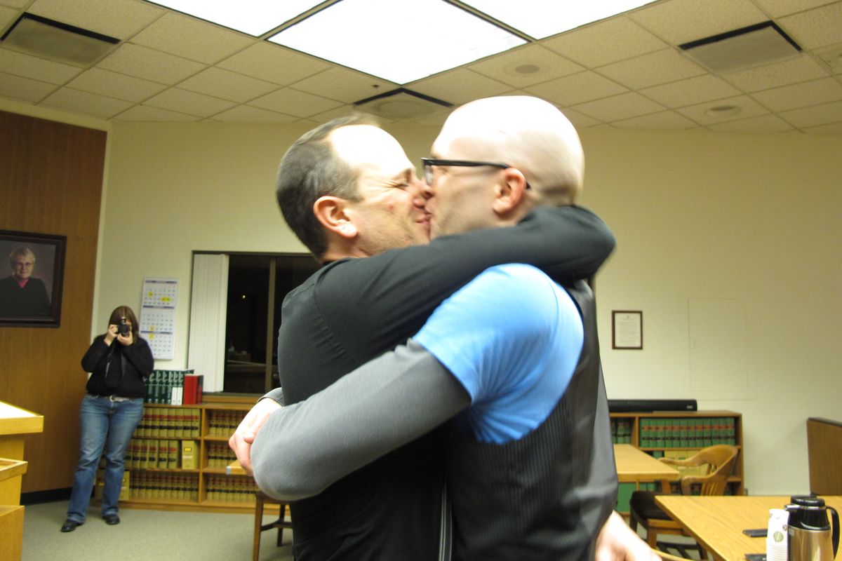 Matthew Wiltse, right, and Jonathon Bashford, left, kiss after they took their wedding vows at the Thurston County Courthouse just after midnight on Sunday, Dec. 9, 2012, in Olympia, Wash. Sunday is the first day same-sex couples can marry under Washington state