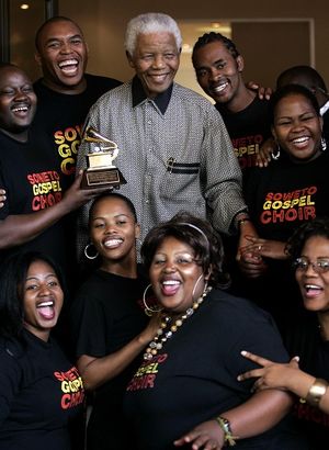 Former South African President Nelson Mandela poses for a photo, as he congratulates the Soweto Gospel Choir for winning their second consecutive Grammy Award, in Johannesburg, South Africa, Wednesday March 26, 2008. (AP Photo/Themba Hadebe) ORG XMIT: XTH101 (Themba Hadebe / The Spokesman-Review)