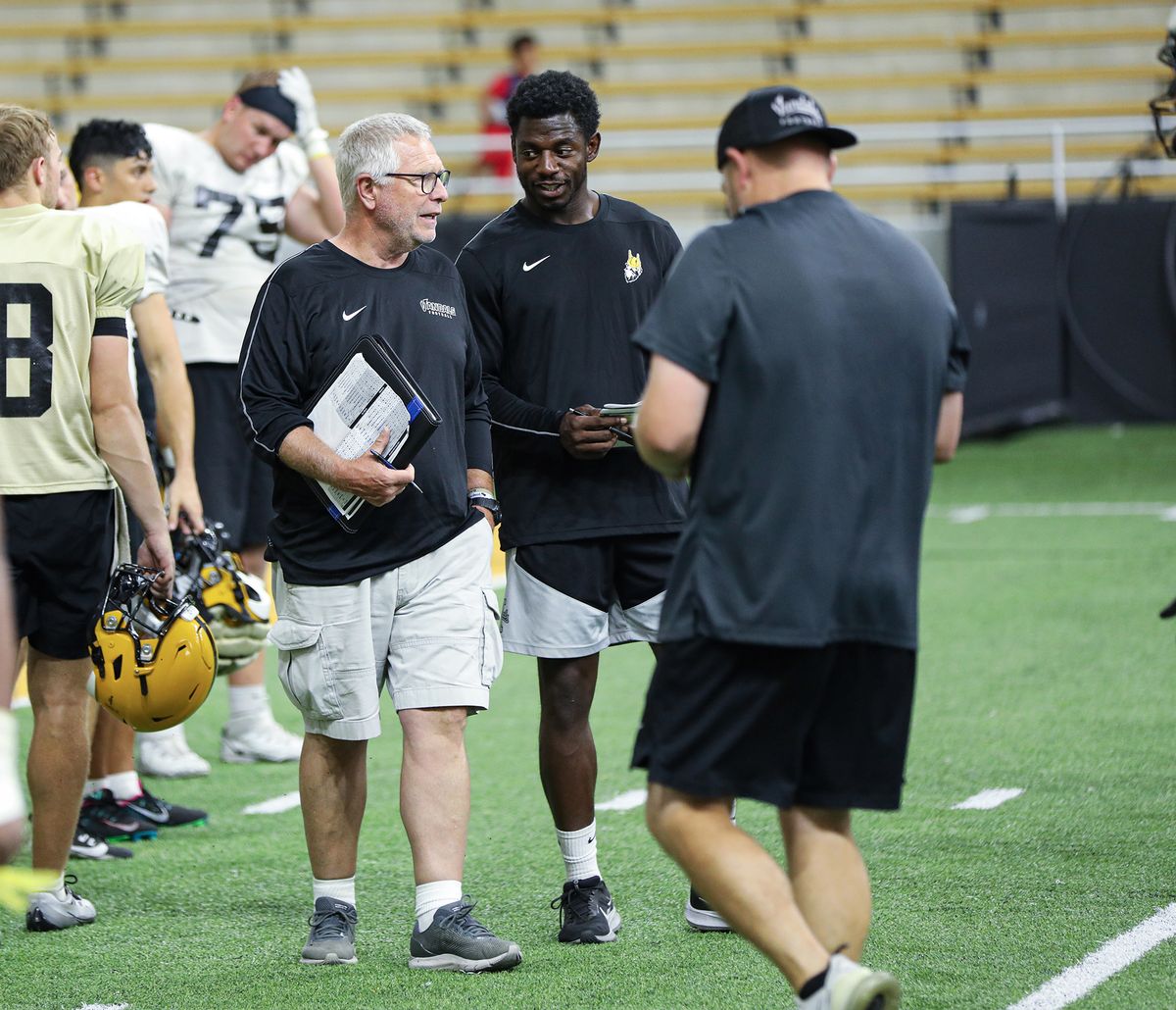 Former South Dakota State coach John Stiegelmeier, center, offered his insights to the Idaho football team last week.  (Courtesy of Idaho athletics)