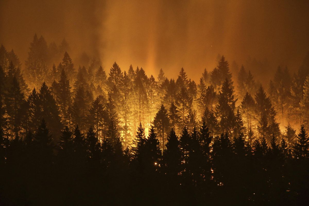 In this Sept. 5, 2017,  photo, the Eagle Creek wildfire burns on the Oregon side of the Columbia River Gorge near Cascade Locks, Ore. (Genna Martin / ASSOCIATED PRESS)