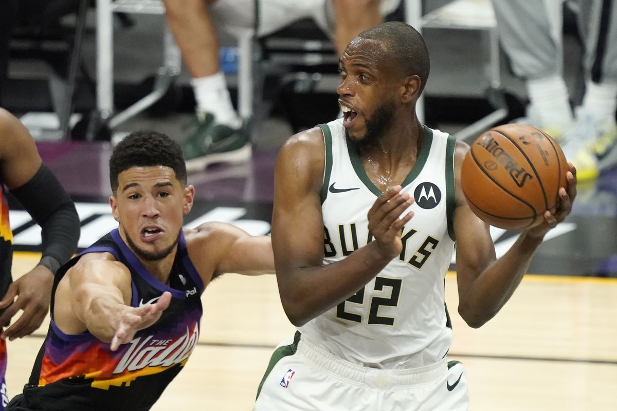 Milwaukee Bucks forward Khris Middleton (22) is defended by Phoenix Suns guard Devin Booker during the second half of Game 2 of basketball