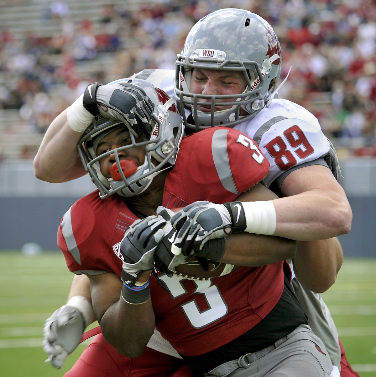 Travis Long stops running back Carl Winston during the Crimson and Gray Game on Saturday. (Dan Pelle)