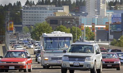 Commuters, RVs and commercial traffic fill Division Street in  Spokane on Thursday. Some residents have changed their travel plans this weekend because of higher gas prices. (Christopher Anderson / The Spokesman-Review)