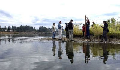 
A group of environmentalists talk to the media while staking a mining claim on Blackwell Island on Thursday. 
 (Jesse Tinsley / The Spokesman-Review)