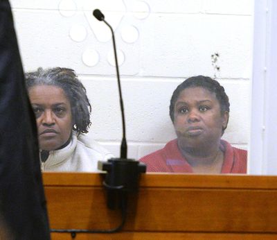 Rachel Hilaire and Peggy LaBossiere appear at Brockton District Court on on Wednesday, Feb. 1, 2018 in Bridgewater, Mass. The two sisters tied down and burned a 5-year-old girl, permanently disfiguring her, in a voodoo ritual meant to rid her of a demon causing her to misbehave, police said. The women also threatened to cut off the head of the unnamed girl's 8-year-old brother with a machete, authorities said. LaBossiere, 51, and Hilaire, 40, denied injuring the girl and threatening the boy and pleaded not guilty Monday, Jan. 29, to mayhem, assault and other charges. (Marc Vasconcellos / The Enterprise)