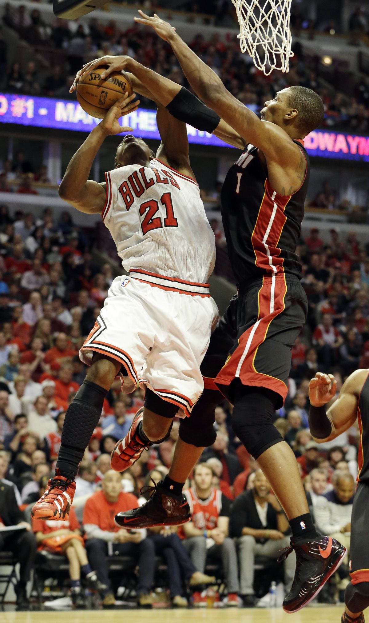 Miami’s Chris Bosh blocks a shot by Chicago’s Jimmy Butler during the second half. (Associated Press)