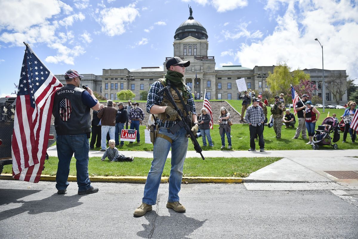 Protesters gather May 20 outside the Montana State Capitol in Helena, Mont. A bill signed into law Thursday by Montana Gov. Greg Gianforte allows concealed firearms to be carried in most places in the state without a permit, and it expands the list of places where guns can be carried to include university campuses and the state Capitol.  (Associated Press)