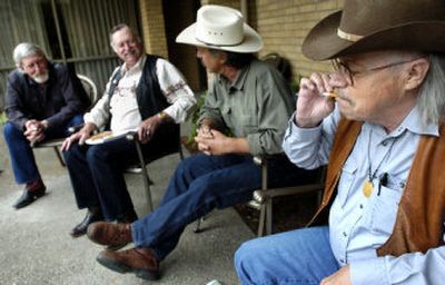 
Robert Conley, far right, of Tahlequah, Okla., smokes a cigarette while chatting with fellow writers, left to right, Rick Steber of Prineville, Ore., Bob Wiseman of Las Vegas, and Tom Ogren of San Luis Obispo, Calif., at a conference in Spokane Valley. 
 (Holly Pickett / The Spokesman-Review)
