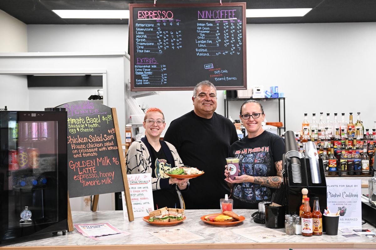 Roger Villareal, center, stands with staff members Gem Aragon, left, and Janis Rountree, with a selection of their offerings on Nov. 12 at Beans and Berries Café in the Spokane Valley. (Tyler Tjomsland/The Spokesman-Review)