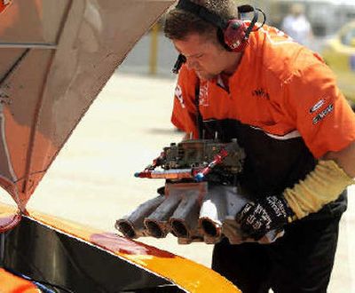 A crew member removes the manifold from Tony Stewart's car after he crashed.
(Associated Press / The Spokesman-Review)
