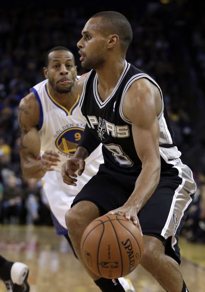 San Antonio’s Patty Mills, right, had 20 points and five rebounds over the Warriors while filling in for an injured Tony Parker. (Associated Press)