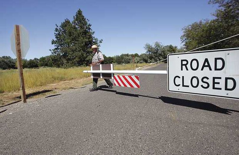 Kavin Carter, Park Ranger with the Army Corps of Engineers, shuts the gate to Hood Park at noon on Tuesday just after the last camper pulled out. Citing budget issues the Corps chose to close area parks more than a month earlier than usual. (Tri-City Herald)