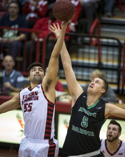 Eastern Washington forward Venky Jois, left, tipping off against North Dakota, is one of five Australian players on the team (Colin Mulvany / The Spokesman-Review)