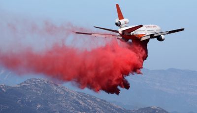 A DC-10 aerial tanker makes a retardant drop on an unburned area as efforts to fight the Jesusita fire continue in the mountains above Santa Barbara, Calif., on Friday.  (Associated Press / The Spokesman-Review)
