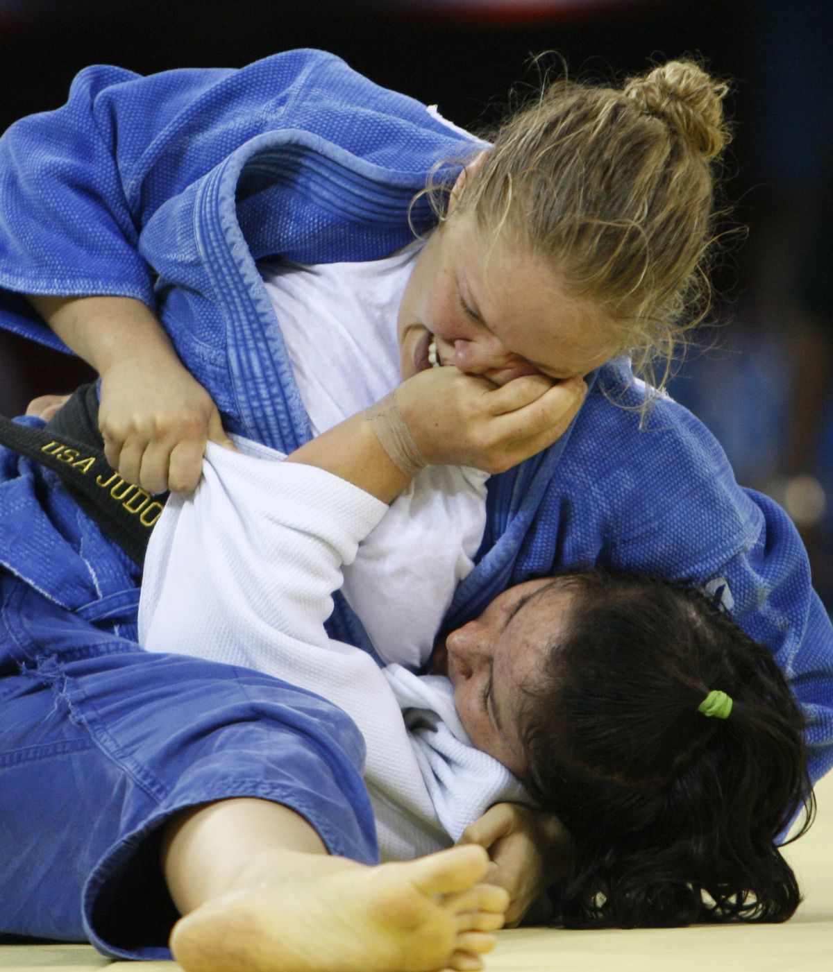 USA’s Ronda Rousey, top, and Nasiba Surkieva of Turkmenistan battle it out in the women’s 70kg judo middleweight division preliminaries at the Beijing Olympics.  (Associated Press / The Spokesman-Review)