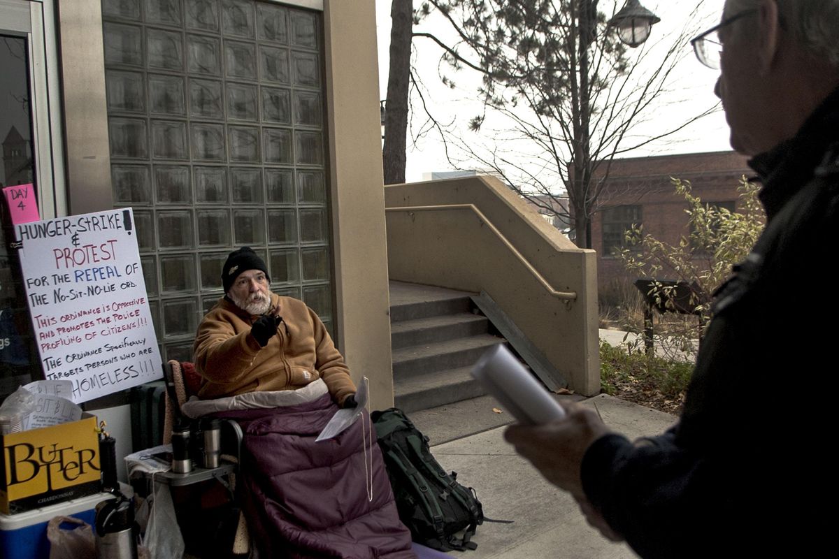 Alfredo LLamedo, left, argues Thursday with John Vowell who volunteers at Union Gospel Mission in front of City Hall in Spokane. Alfredo is holding a hunger strike to protest the no sit no lie ordinance. (Kathy Plonka / The Spokesman-Review)