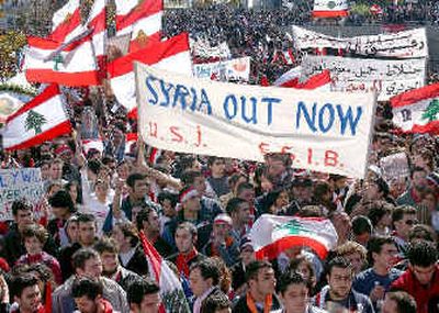 
Protestors carry Lebanese flags and anti-Syria banners during a street demonstration in Beirut, Lebanon, on Monday. Thousands of opposition supporters shouted insults at Syria and demanded the resignation of their pro-Syrian government during the gathering in the capital city. 
 (Associated Press / The Spokesman-Review)