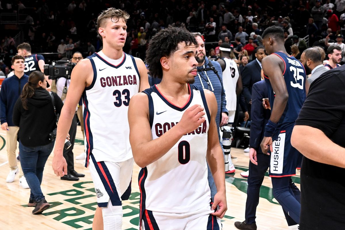 Gonzaga Bulldogs forward Ben Gregg (33) and guard Ryan Nembhard (0) head to the locker room after falling to the Connecticut Huskies during the second half of of a college basketball game on Friday, Dec. 15, 2023, at Climate Pledge Arena in Seattle, Wash. The Connecticut Huskies won the game 76-63.  (Tyler Tjomsland/The Spokesman-Review)