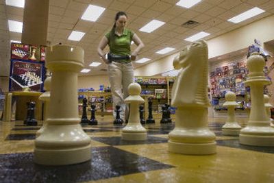 
Store manager Heather Sproul sets up a giant chessboard at Uncle's Games and Puzzles in NorthTown Mall. 
 (CHRISTOPHER ANDERSON / The Spokesman-Review)