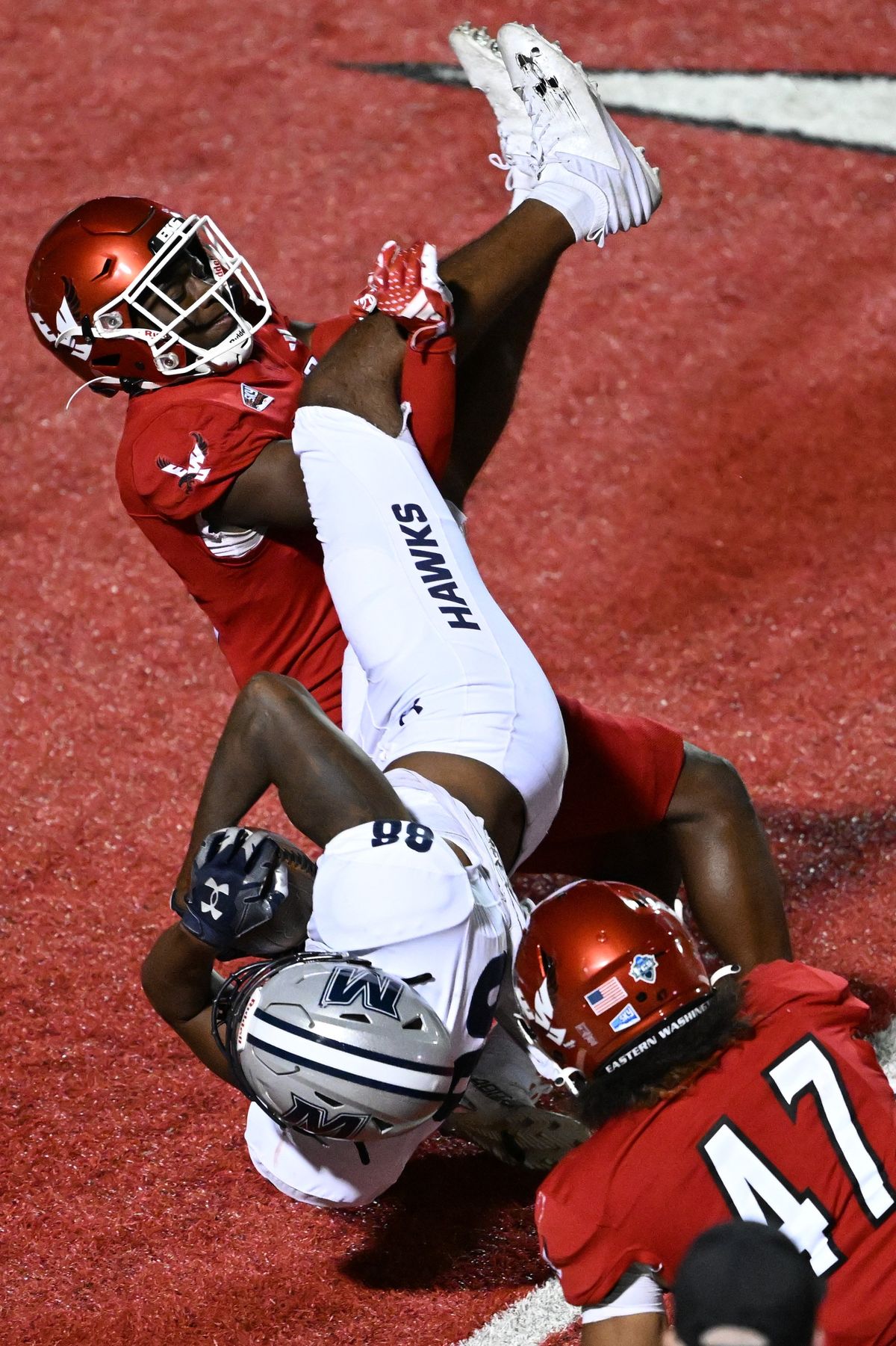Eastern Washington Eagles cornerback DaJean Wells (3) and linebacker Samarai Anderson (47) stop Monmouth Hawks tight end Marcus Middleton (88) on a run during the second half of a college football game on Thursday, Aug. 29, 2024, at Roos Field in Cheney, Wash.  (Tyler Tjomsland/The Spokesman-Review)