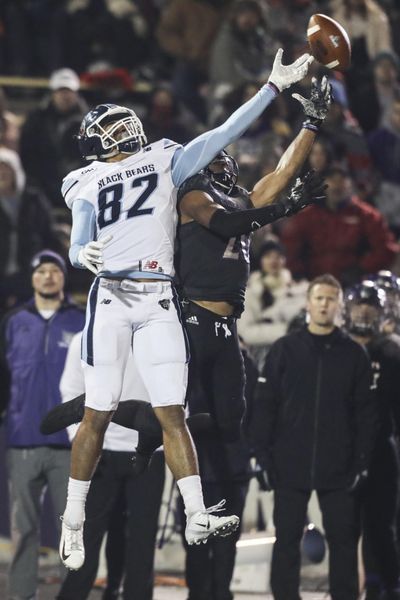 Weber State’s Parker Preator  attempts to intercept a pass intended for Maine’s Andre Miller (82) during the first half of an FCS quarterfinal  last Friday  in Ogden, Utah. (Matt Herp / AP)