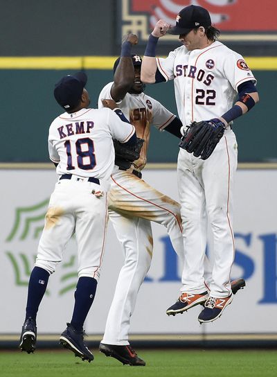 Houston Astros' Tony Kemp (18), Cameron Maybin, center, and Josh Reddick celebrate the team's win over the New York Mets in the first game of a baseball doubleheader, Saturday, Sept. 2, 2017, in Houston. Houston won 12-8. (Eric Christian Smith / Associated Press)
