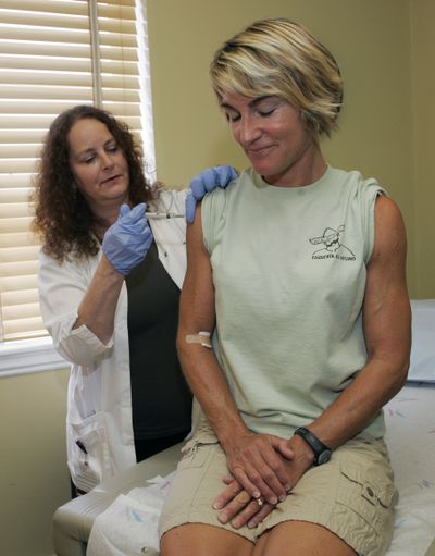 Carolyn Atherholtz receives an  H1N1 flu vaccine from  nurse Wendy Nesheim at Emory University in Atlanta on Monday.  (Associated Press / The Spokesman-Review)