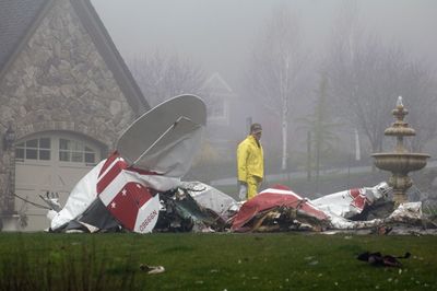 An FAA official investigates the scene of a  plane crash in Newberg, Ore., on Wednesday. The small plane crashed into a residential area.  (Associated Press / The Spokesman-Review)