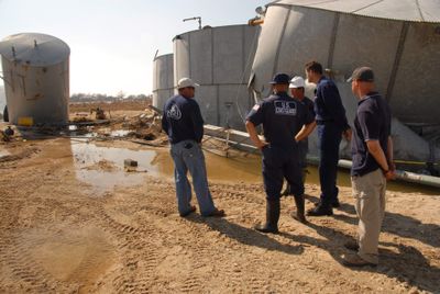 U.S. Coast Guard Unified Command responders discuss conditions at a diesel spill site on Goat Island, Texas,  on Sept. 25.  (Associated Press / The Spokesman-Review)