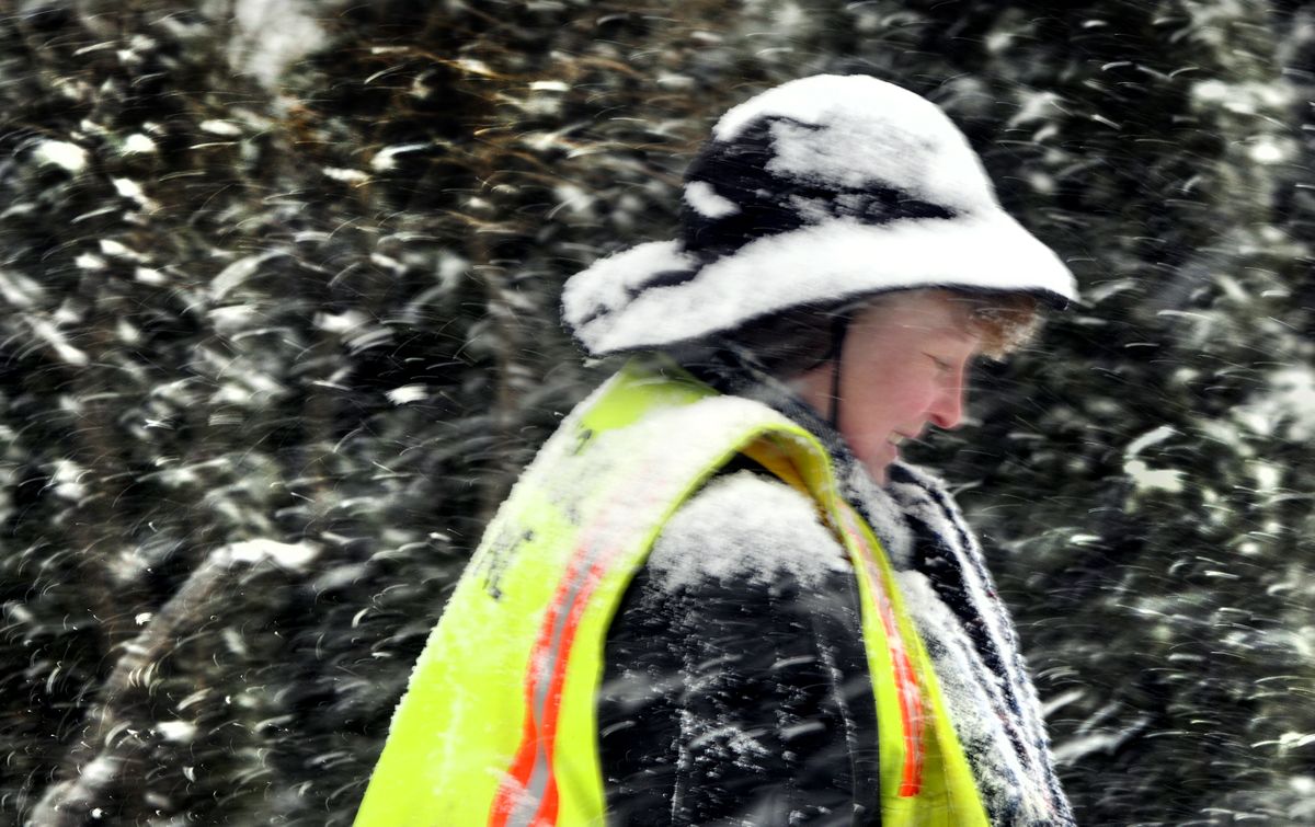 Crossing guard Sheree Wilkinson heads for her car Monday after helping Roosevelt Elementary School children cross 14th Avenue and Lincoln Street.  (Colin Mulvany / The Spokesman-Review)