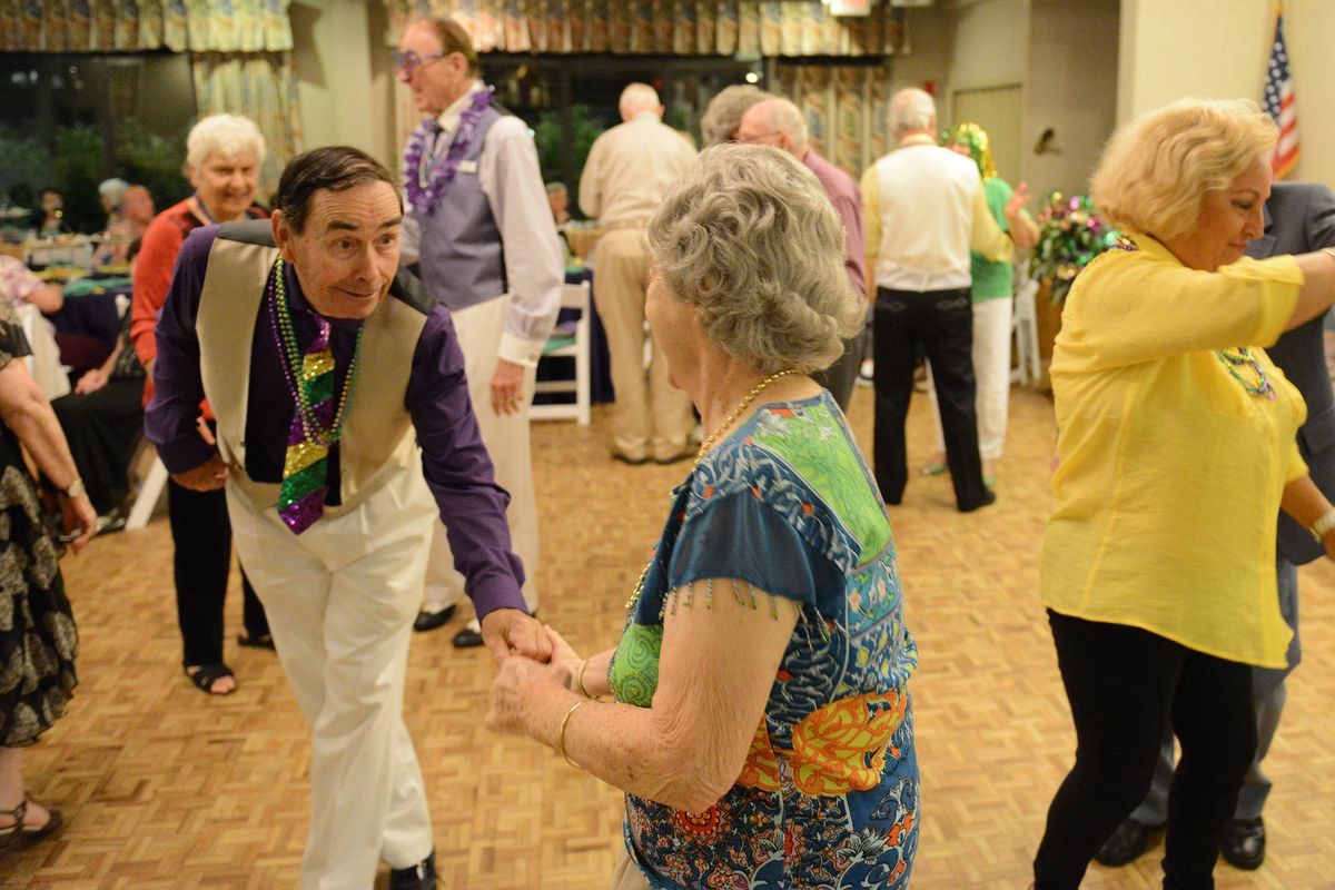 Hired dancer Mike Campbell, left, dances with Jackie Bowman during a Mardi Gras party at Abbey Delray in Delray Beach, Florida.