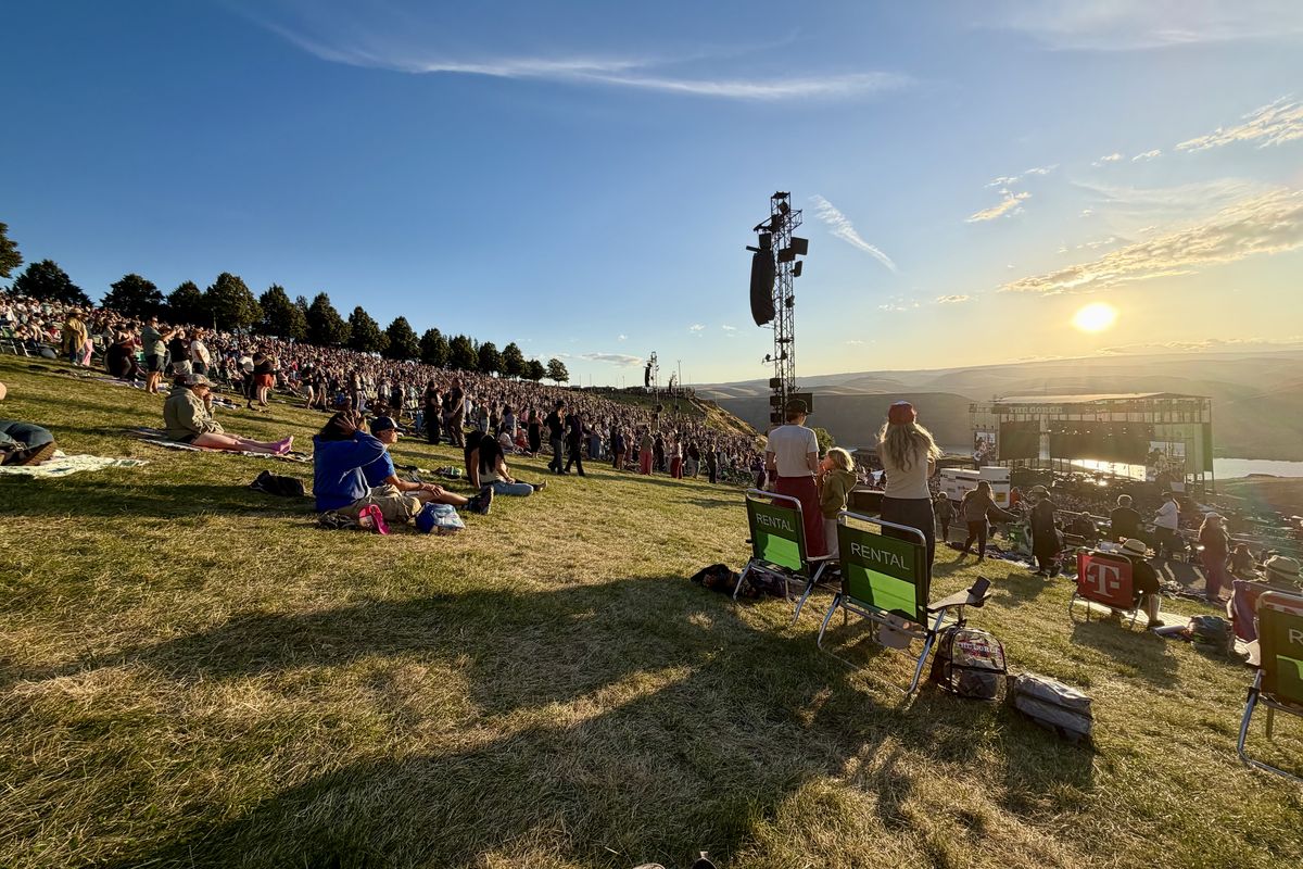 The sun sets behind the Gorge Amphitheatre stage and Columbia River on Sunday in Quincy, Wash., as concertgoers attend the final day of the three-night concert series “Echoes Through the Canyon.”  (Caitlin Miller/The Spokesman-Review)