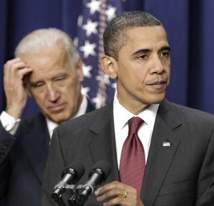 President Barack Obama, joined by Vice President Joe Biden at left, speaks Friday before signing the bipartisan tax package.  (Associated Press)