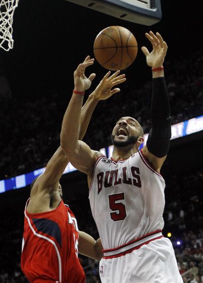 Carlos Boozer (5) and Chicago are one-half game up on Boston. (Associated Press)