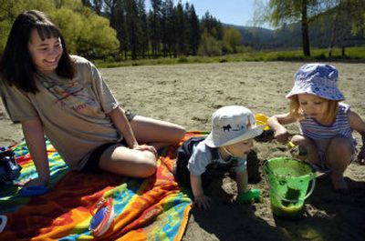 
Casi Densley watches as her children Austin and Halli play with the sand on the beach Liberty Lake County Park. 