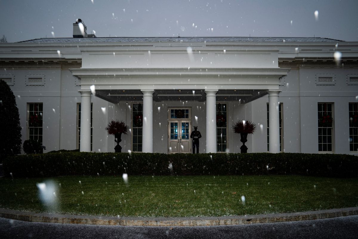 A Marine stands guard outside the West Wing, signifying the president is in the Oval Office, as snow begins to fall at the White House on Dec. 16, 2020. MUST CREDIT: Washington Post photo by Jabin Botsford.  (Jabin Botsford/The Washington Post)