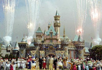 
Officials stand with well-known Disney characters as fireworks go off to celebrate the 50th anniversary of Disneyland on Sunday.
 (Associated Press / The Spokesman-Review)