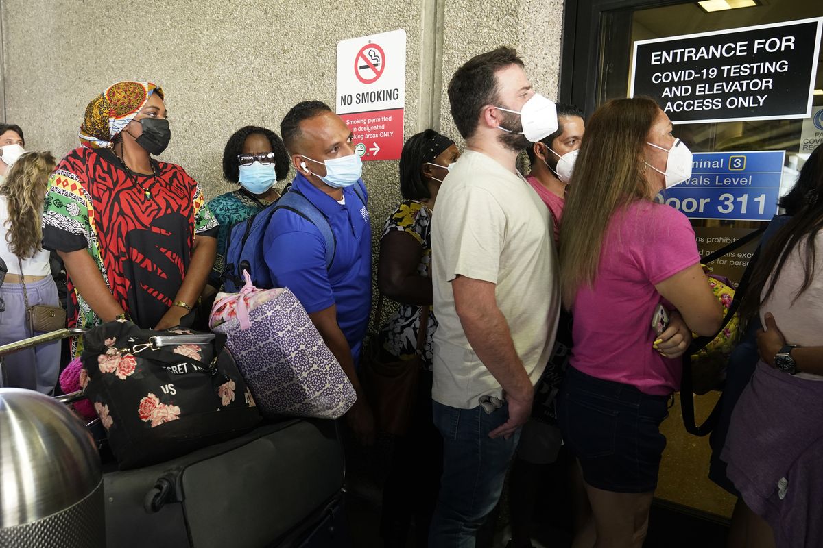 Passengers wait in a long line to get a COVID-19 test to travel overseas at Fort Lauderdale-Hollywood International Airport, Friday, Aug. 6, 2021, in Fort Lauderdale, Fla. Recent flight cancelations caused many passengers to redo their tests while others were unable to get the test locally due to long lines caused by the surge of the Delta variant.  (Marta Lavandier)